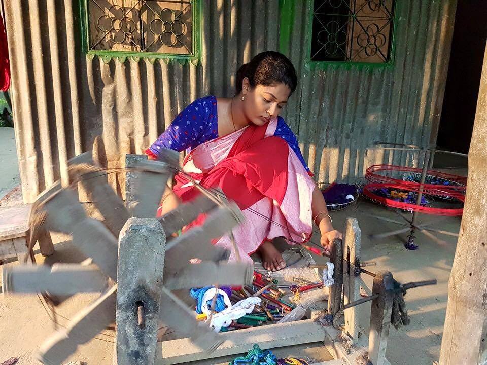 Lady spinning in charkha